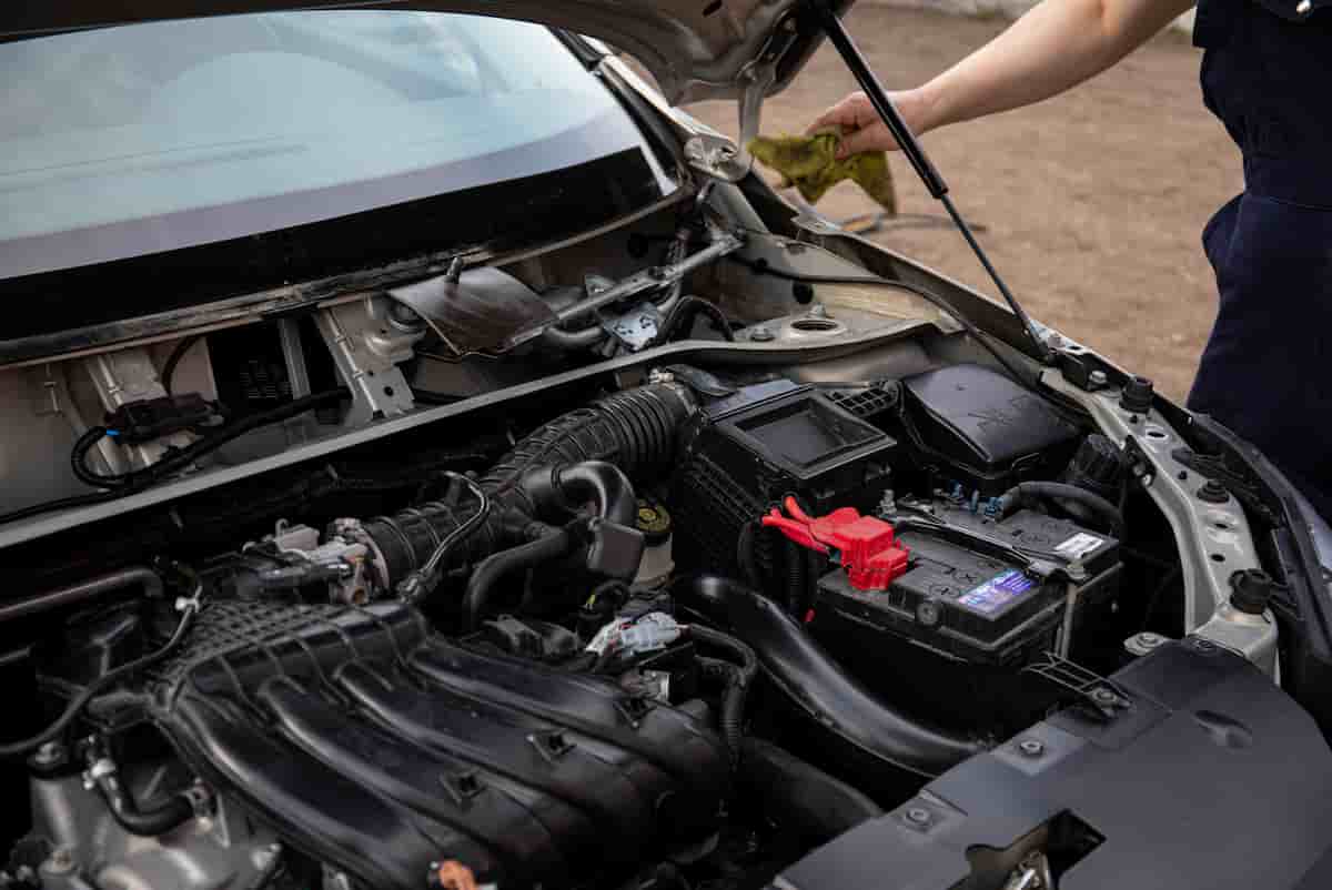 On-site car repair in a parking lot along K-18 in Kansas